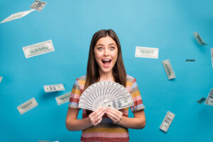 money raises Close-up portrait of her she nice lovely pretty amazed crazy overjoyed cheerful cheery girl holding in hand fan cashback sale discount isolated over bright vivid shine vibrant blue color background