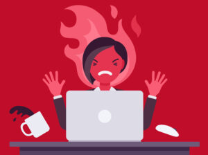 Businesswoman working with laptop flamed in anger