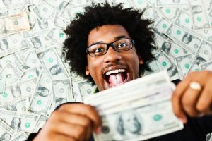money diverse Overjoyed young man surrounded by US dollars